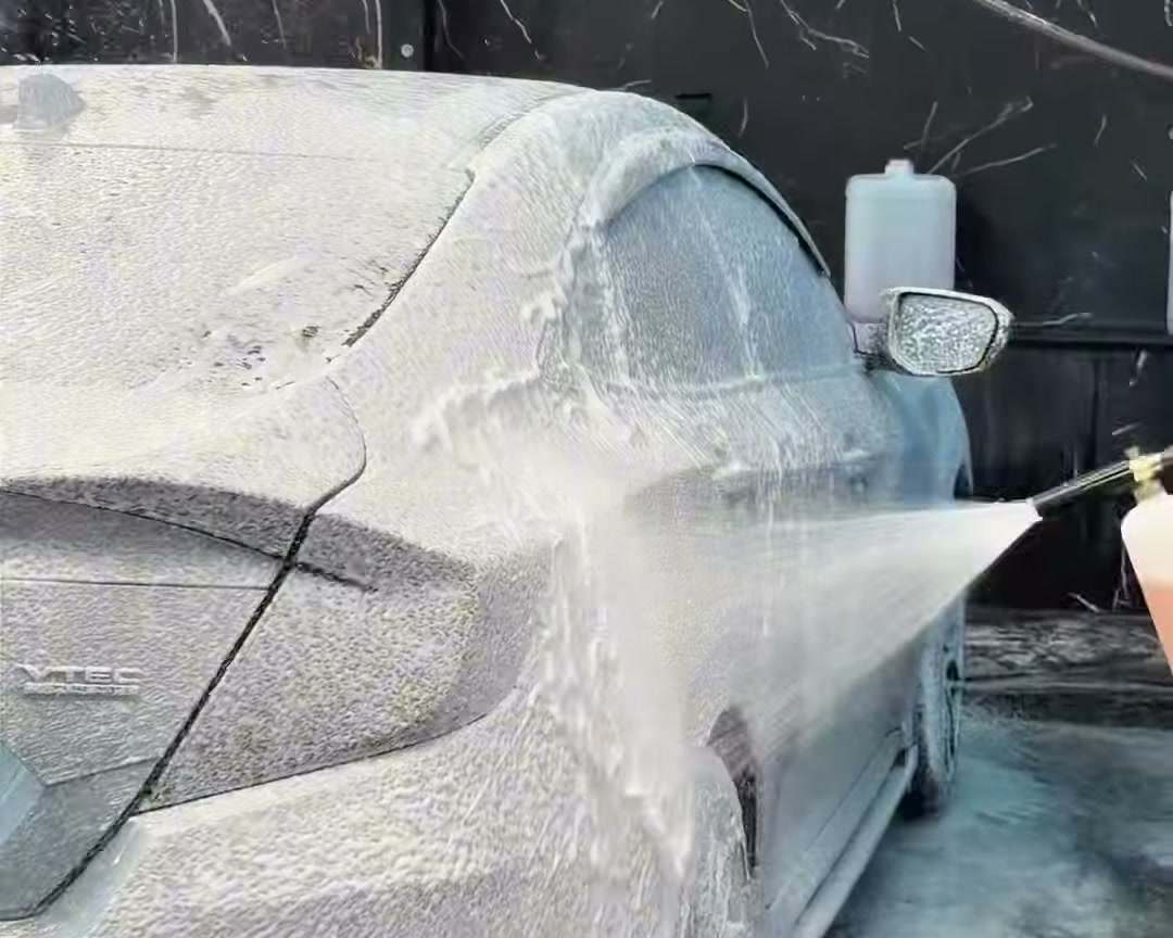 A car covered in thick snow foam as it is sprayed by hand at White Diamond Haberfield